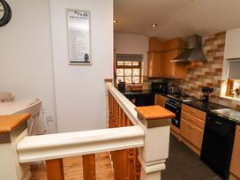 A kitchen with cabinets and appliances at Heather Cottages - Grey Seal Bamburgh