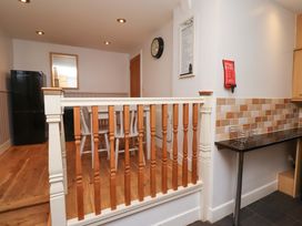A kitchen with a dining table and chairs at Heather Cottages - Grey Seal in Bamburgh
