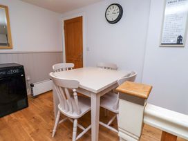 A dining room with a table and chairs at Heather Cottages - Grey Seal Bamburgh