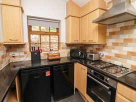 A kitchen with appliances including a fridge and oven at Heather Cottages - Grey Seal in Bamburgh