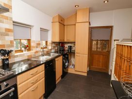 A kitchen with cabinets and appliances at Heather Cottages - Grey Seal in Bamburgh