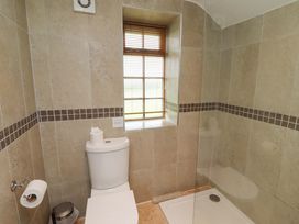 A bathroom with a shower and toilet at Heather Cottages - Grey Seal in Bamburgh