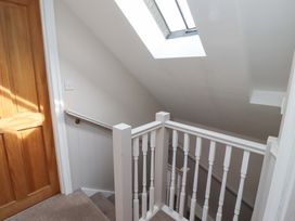 A staircase with a door and skylight at Heather Cottages - Grey Seal in Bamburgh