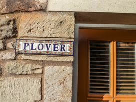 A nameplate on a stone wall at Heather Cottages - Plover in Bamburgh