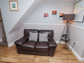 A living room with a sofa and lamp at Heather Cottages - Plover in Bamburgh