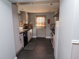 A kitchen with appliances and a window at Heather Cottages - Plover in Bamburgh