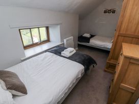 A bedroom with two beds and a window at Heather Cottages - Plover in Bamburgh