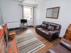 A living room with a sofa and television at Kittiwake Cottage, Budle Bay Bamburgh