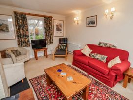 A living room with a sofa and television at St Marys Cottages No4 Low Newton-by-the-Sea