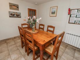 A dining room with a wooden table and chairs at St Marys Cottages No4 Low Newton-by-the-Sea
