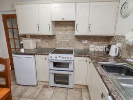 A kitchen with an oven and sink at St Marys Cottages No4 Low Newton-by-the-Sea
