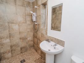 A bathroom with a shower, sink, and toilet at St Marys Cottages No4 Low Newton-by-the-Sea