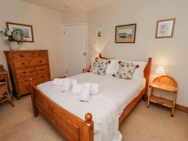 A bedroom with a bed and a dresser at St Marys Cottages No4 Low Newton-by-the-Sea