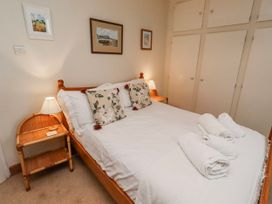 A bedroom with a bed and bedside table at St Marys Cottages No4 Low Newton-by-the-Sea