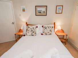 A bedroom with a bed and side tables at St Marys Cottages No4 Low Newton-by-the-Sea