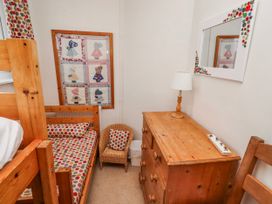 A bedroom with a bunk bed and dresser at St Marys Cottages No4 Low Newton-by-the-Sea