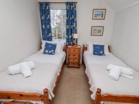 A bedroom with two beds and a bedside table at St Marys Cottages No4 in Low Newton-by-the-Sea