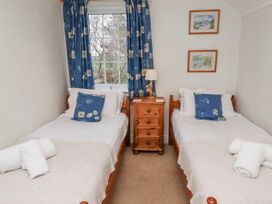 A bedroom with two beds and a window at St Marys Cottages No4 Low Newton-by-the-Sea