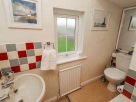 A bathroom featuring a sink and toilet at St Marys Cottages No4 in Low Newton-by-the-Sea