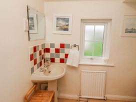 A bathroom with a sink and mirror at St Marys Cottages No4 Low Newton-by-the-Sea