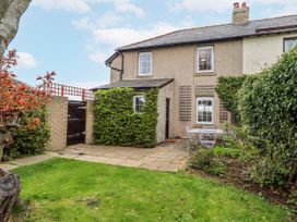 A garden with a patio table and chairs at St Marys Cottages No4 in Low Newton-by-the-Sea