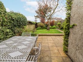 A garden with a table and chairs at St Marys Cottages No4 in Low Newton-by-the-Sea