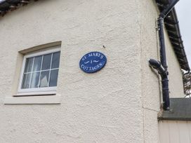 A sign indicating St Mary's Cottages No4 in Low Newton-by-the-Sea
