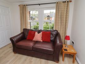 A living room with a sofa and window at Sugar Sands in Longhoughton
