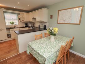 A kitchen with a table and chairs at Sugar Sands in Longhoughton