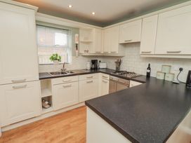 A kitchen with cabinets and sink at Sugar Sands in Longhoughton
