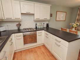 A kitchen with a stove and sink at Sugar Sands in Longhoughton