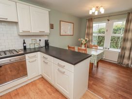 A kitchen with a stove, sink, and dining area at Sugar Sands in Longhoughton