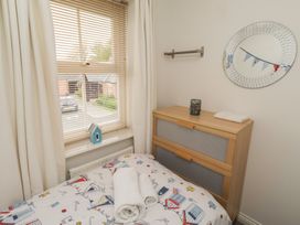 A bedroom with a bed and chest of drawers at Sugar Sands in Longhoughton