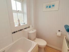 A bathroom with a bath tub and toilet at Sugar Sands in Longhoughton
