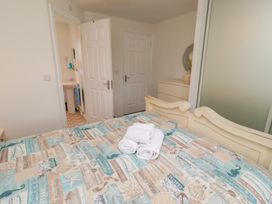 A bedroom with a bed and towels on it at Sugar Sands in Longhoughton