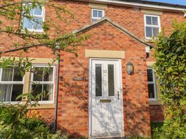 Front view of a house with a door and windows at Sugar Sands in Longhoughton