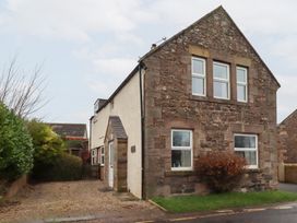 A house with windows and a door at Wayside Cottage in Newton-by-the-Sea