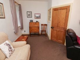 A living room with seating and a wooden chest of drawers at Wayside Cottage in Newton-by-the-Sea