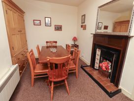 A dining room with a table and chairs at Wayside Cottage in Newton-by-the-Sea