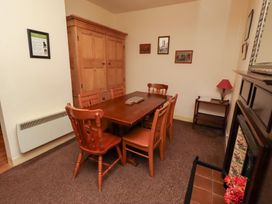 A dining room with a table and chairs at Wayside Cottage Newton-by-the-Sea
