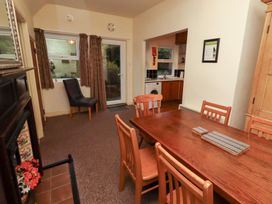 A dining room with table and chairs at Wayside Cottage in Newton-by-the-Sea