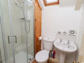 A bathroom with shower, toilet, and sink at Wayside Cottage in Newton-by-the-Sea