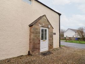 A front entrance with a door and porch at Wayside Cottage in Newton-by-the-Sea