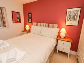 A bedroom with a bed and bedside tables at Wynding Down in Bamburgh