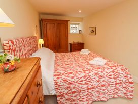 A bedroom with a double bed and wardrobe at Wynding Down in Bamburgh