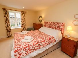 A bedroom with a bed and bedside table at Wynding Down in Bamburgh