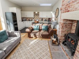 A living room with a sofa and fireplace at Red Fox in Lucker