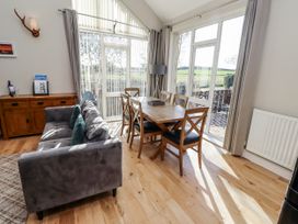 A dining room with a sofa and dining table at Red Fox in Lucker