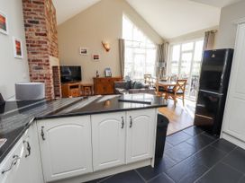 A kitchen and living room with a counter and seating at Red Fox in Lucker