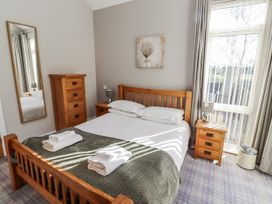 A bedroom with a bed and nightstand at Red Fox in Lucker